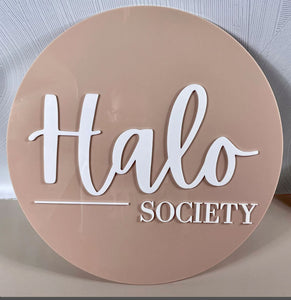 Round Halo Society sign in blush tone with raised white script lettering.